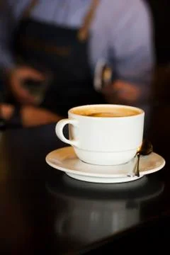 The white Cup of black espresso coffee at the bar counter in cafe Stock Photos