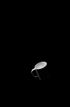 White cup in black space. Stock Photos