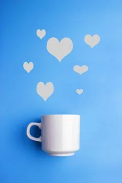White cup on blue background Stock Photos