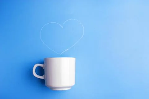 White cup on blue background Stock Photos
