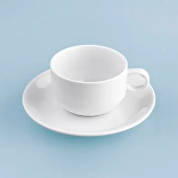 White cup on blue background solid Stock Photos