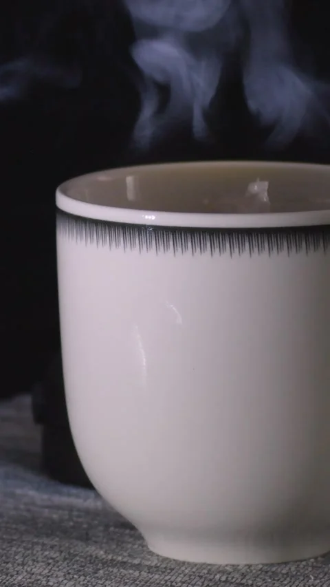 White cup with boiling water, tea bag, dark background, steam Stock Footage 301906448