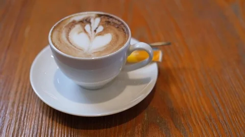 A white cup of cappuccino coffee on table with copy space Stock Footage 98981565