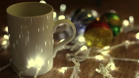 White cup on Christmas lights Stock Footage 80990277