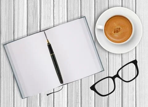White cup of coffee and opened blank notebook on wooden background Fotos Stock