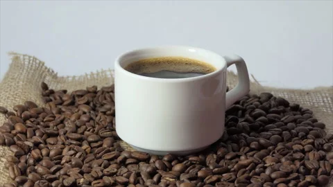 White cup with coffee on the background of fresh roasted coffee beans Stock Footage 195460095