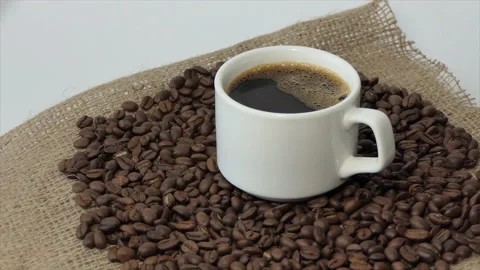 White cup with coffee on the background of fresh roasted coffee beans Stock Footage 195939541