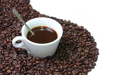 White cup on coffee bean Stock Photos