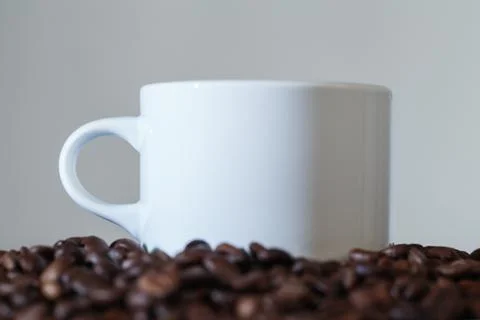 White Cup in Coffee Beans Stock Photos