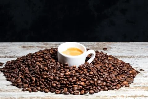 White cup of coffee on beans Stock Photos