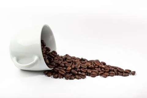 White cup with coffee beans on white background Stock Photos