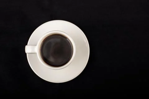 White cup of coffee on black surface Stock Photos