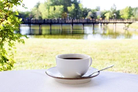 A white cup of coffee close-up is on the table 스톡 사진