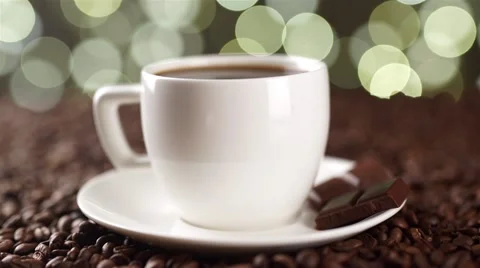 White cup of coffee on coffee beans with a spoon prevent sugar Stock Footage 56424991