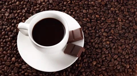 White cup of coffee on coffee beans add milk or cream Stock Footage 56425819