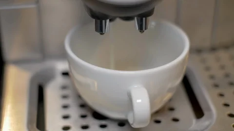 A white cup of coffee. Coffee machine makes a latte macchiato, cappuccino Stock Footage 116748764