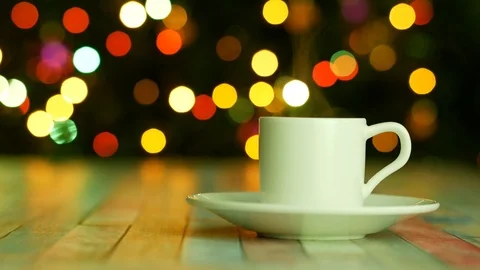 White cup of coffee on the dark background with bokeh lights Video stock 122688881