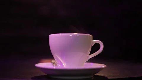 White cup of coffee on a dark background. freshly brewed espresso. Stock Footage 229567196