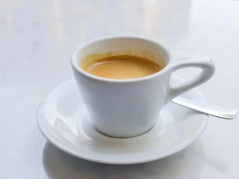 White cup of coffee on marble surface Foto stock