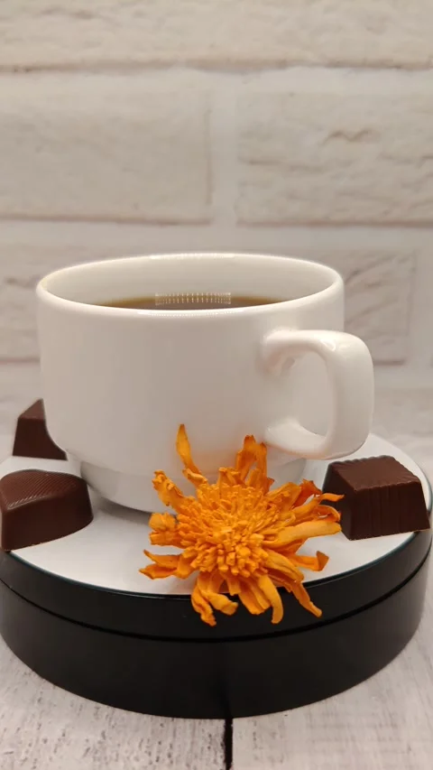 A white cup of coffee is spinning around close up Stock Footage 329936359