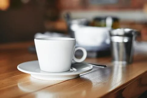 White cup of coffee on the table in cafe restaurant Stock Photos