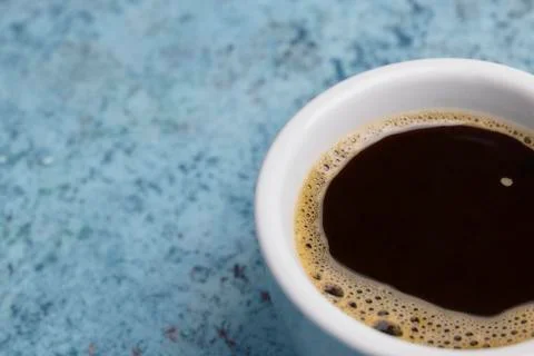 White cup with coffee on the table. close up of a drink. place for text. Abst Stock Photos
