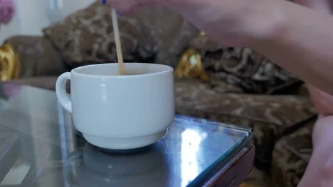 A white cup of coffee is on the table. Stock Footage 80325516