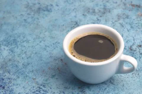 White cup with coffee on the table. horizontal view. place for text. Abstract Stock Photos