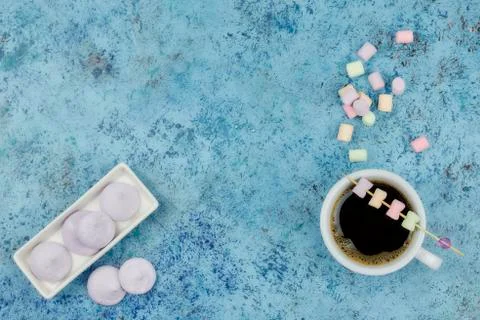 White cup with coffee on the table. marshmallows view from above. place for t Stock Photos