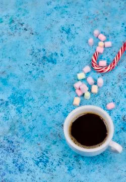 White cup with coffee on the table. marshmallows view from above. place for t Stock Photos