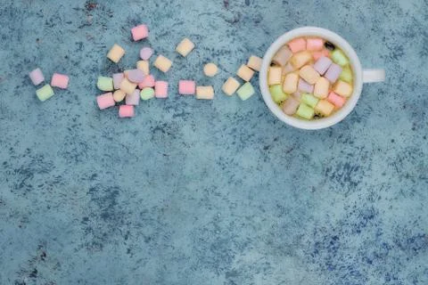 White cup with coffee on the table. marshmallows view from above. place for t Stock Photos
