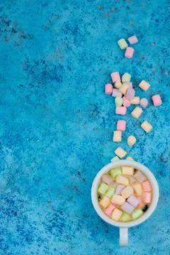 White cup with coffee on the table. marshmallows view from above. place for t Stock Photos