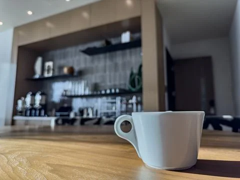 White cup of coffee on the table. Stock Photos