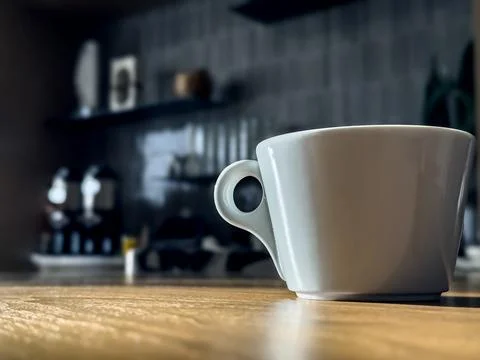White cup of coffee on the table. Stock Photos