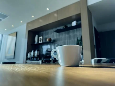 White cup of coffee on the table. Stock Photos