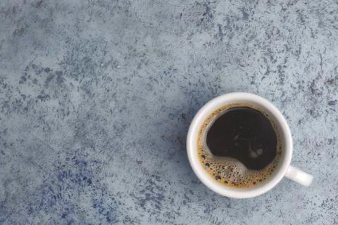 White cup with coffee on the table. view from above. place for text. Abstract Stock Photos