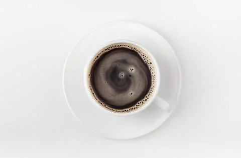 A white cup of coffee on a white background. Morning coffee. Top view. Stock Photos