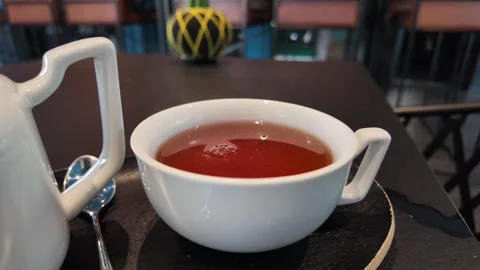 A white cup filled with steaming tea. Stock Footage 317628930