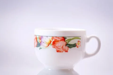 White cup with flowers theme. Foto stock
