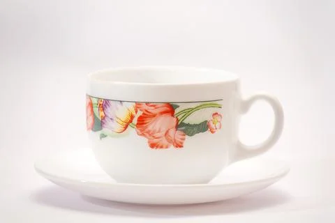 White cup with flowers theme. Stock Photos