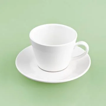 White cup on green yellow background solid Stock Photos