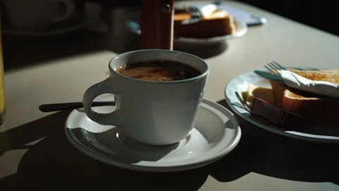 In white cup with hot black coffee added milk. Closeup shot. Stock Footage 168580304