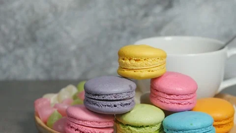 White cup of hot coffee and colorful macaroons dessert food on dish Stock-Footage 75336472