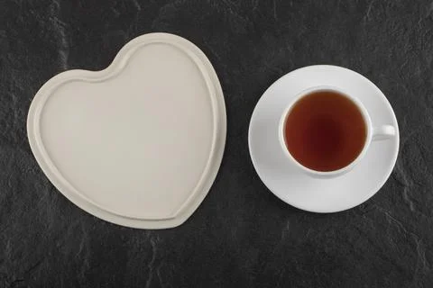 A white cup of hot tea with an empty plate Stock Photos