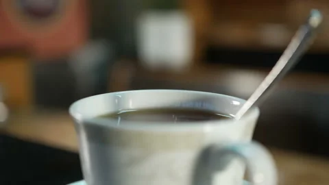 White cup of hot tea stand on the table, with a beautiful curly steam Stock Footage 123416191