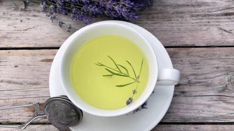 White cup with lavender tea and fresh lavender flowers Stock Footage 248770072