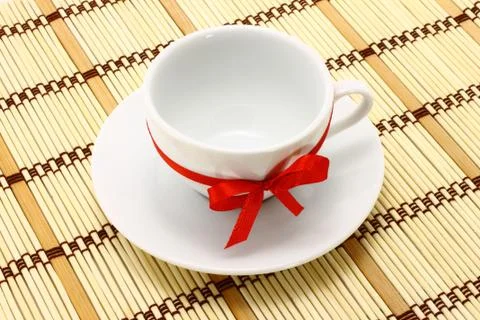 White cup with red bow Stock Photos