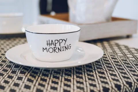 White cup with saucer on the table Stock Photos