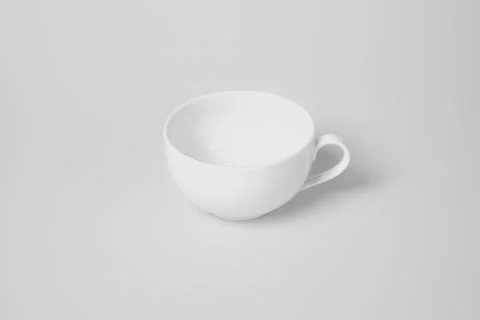A white cup sits on a white background Stock Photos