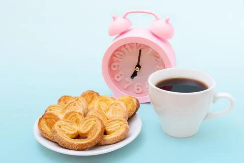 White cup of steaming hot black coffee or hot chocolate, freshly baked heart  Stock Photos